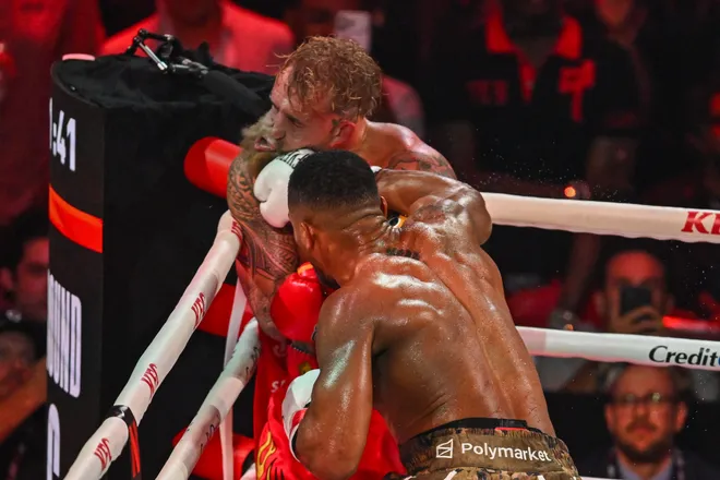 US boxer and influencer Jake Paul gets hit by British boxer Anthony Joshua (R) in a non-title heavyweight bout at the Kaseya Center in Miami, Florida on December 19, 2025. (Photo by Giorgio VIERA / AFP via Getty Images)