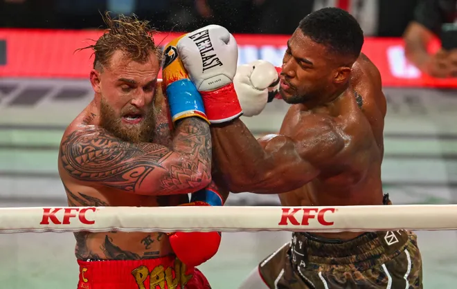 US boxer and influencer Jake Paul (L) and British boxer Anthony Joshua fight in a non-title heavyweight bout at the Kaseya Center in Miami, Florida on December 19, 2025. (Photo by Giorgio VIERA / AFP via Getty Images)