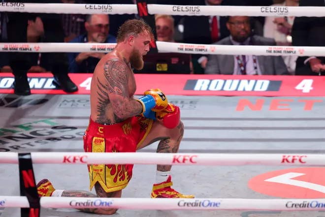Dec 19, 2025; Miami, Florida, UNITED STATES; Jake Paul gets up from the canvas after falling against Anthony Joshua during a heavyweight boxing bout at Kayesa Center. Mandatory Credit: Sam Navarro-Imagn Images