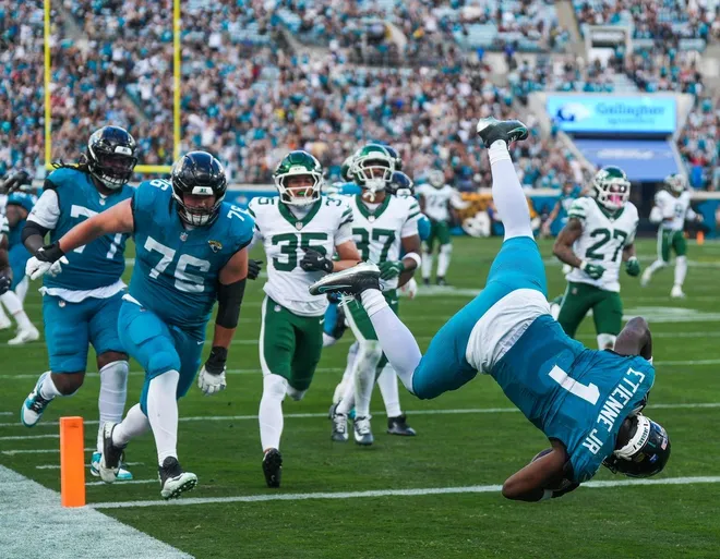 Jacksonville Jaguars running back Travis Etienne Jr. (1) leaps into the end zone for a fourth quarter touchdown during an NFL football game at EverBank Stadium, Sunday, Dec. 14, 2025, in Jacksonville, Fla. The Jaguars defeated the Jets 48-20. [Doug Engle/Florida Times-Union]