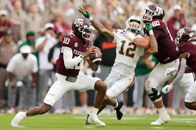 COLLEGE STATION, TEXAS - DECEMBER 20: Marcel Reed #10 of the Texas A&M Aggies drops back to pass in the first quarter against the Miami Hurricanes during the 2025 College Football Playoff First Round Game at Kyle Field on December 20, 2025 in College Station, Texas. (Photo by Alex Slitz/Getty Images)
