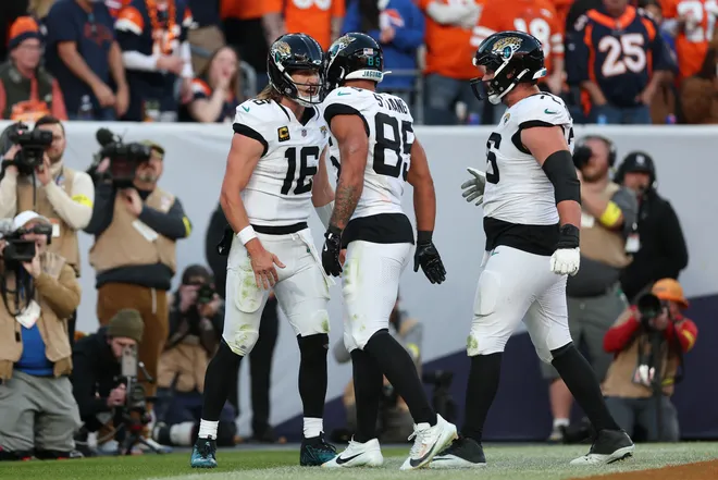 DENVER, COLORADO - DECEMBER 21: Trevor Lawrence #16 of the Jacksonville Jaguars celebrates a third quarter touchdown against the Denver Broncos at Empower Field At Mile High on December 21, 2025 in Denver, Colorado. (Photo by Matthew Stockman/Getty Images)