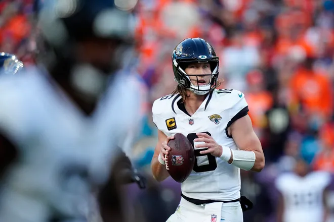 Dec 21, 2025; Denver, Colorado, USA; Jacksonville Jaguars quarterback Trevor Lawrence (16) drops back to pass against the Denver Broncos during the first half at Empower Field at Mile High. Mandatory Credit: Ron Chenoy-Imagn Images