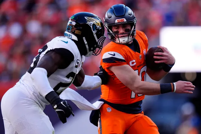 Dec 21, 2025; Denver, Colorado, USA; Denver Broncos quarterback Bo Nix (10) rushes the ball against the Jacksonville Jaguars during the first half at Empower Field at Mile High. Mandatory Credit: Ron Chenoy-Imagn Images
