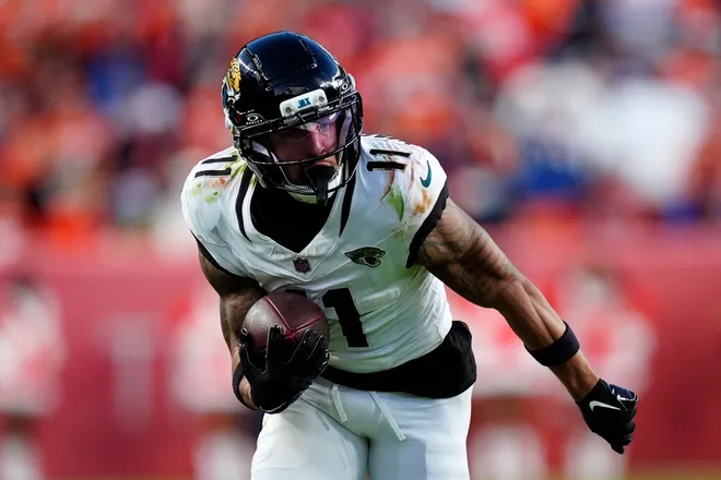 Dec 21, 2025; Denver, Colorado, USA; Jacksonville Jaguars wide receiver Parker Washington (11) makes a catch against the Denver Broncos during the second half at Empower Field at Mile High. Mandatory Credit: Ron Chenoy-Imagn Images