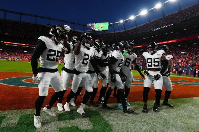 Dec 21, 2025; Denver, Colorado, USA; The Jacksonville Jaguars defense reacts during the second half at Empower Field at Mile High. Mandatory Credit: Ron Chenoy-Imagn Images