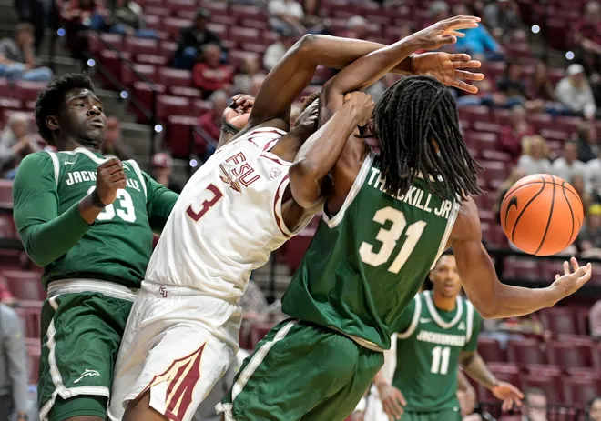 Dec 22, 2025; Tallahassee, Florida, USA; Florida State Seminoles forward Thomas Bassong (3) fights for a rebound against Jacksonville University Dolphins forward Jason Thirdkill Jr. (31) during the first half at Donald L. Tucker Center. Mandatory Credit: Melina Myers-Imagn Images