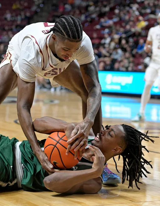 Dec 22, 2025; Tallahassee, Florida, USA; Jacksonville University Dolphins forward Jason Thirdkill Jr. (31) and Florida State University forward Chauncey Wiggins (7) fight for a loose ball during the first half at Donald L. Tucker Center. Mandatory Credit: Melina Myers-Imagn Images