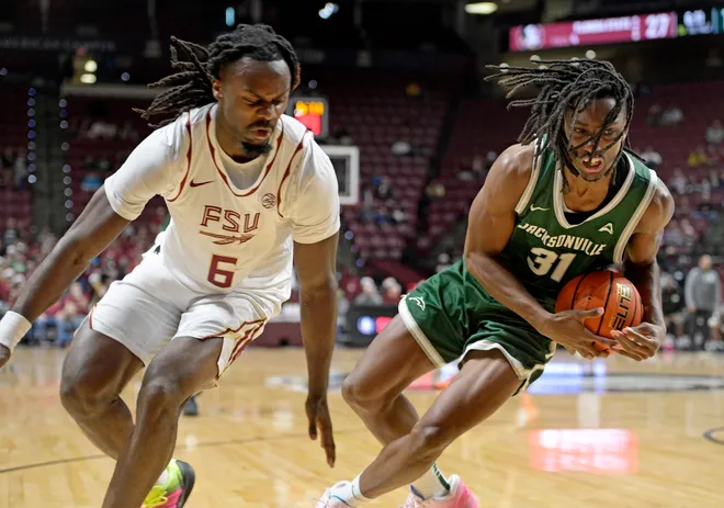 Dec 22, 2025; Tallahassee, Florida, USA; Jacksonville University Dolphins forward Jason Thirdkill Jr. (31) loses control of the ball as Florida State University guard Robert McCray (6) defends during the first half at Donald L. Tucker Center. Mandatory Credit: Melina Myers-Imagn Images