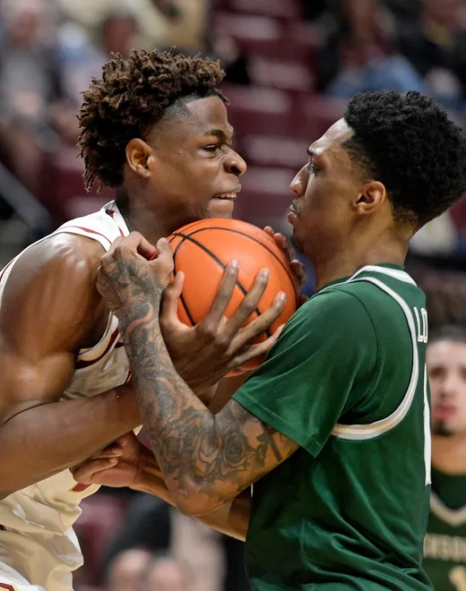 Dec 22, 2025; Tallahassee, Florida, USA; Florida State Seminoles forward Thomas Bassong (3) fights for a rebound against Jacksonville University Dolphins guard Chris Lockett Jr. (11) during the first half at Donald L. Tucker Center. Mandatory Credit: Melina Myers-Imagn Images