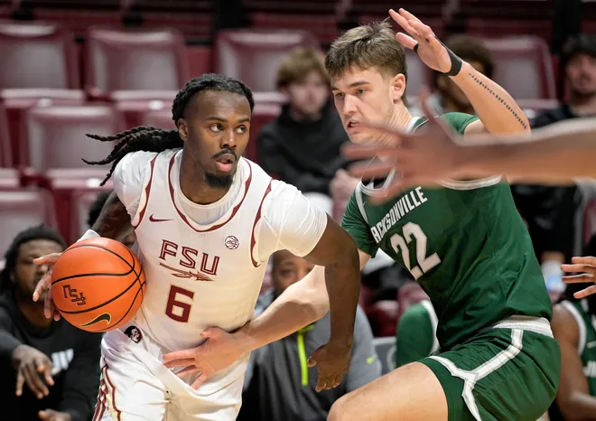 Dec 22, 2025; Tallahassee, Florida, USA; Florida State Seminoles guard Robert McCray (6) drives to the net during the first half against Jacksonville University Dolphins guard Charles Caporaso (22) at Donald L. Tucker Center. Mandatory Credit: Melina Myers-Imagn Images