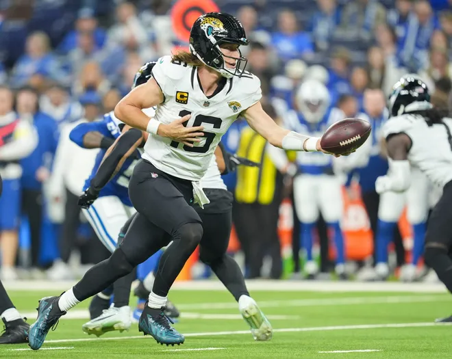 Jacksonville Jaguars quarterback Trevor Lawrence (16) drops back to hand the ball to Jacksonville Jaguars running back Travis Etienne Jr. (1) on Sunday, Dec. 28, 2025, during a game against the Indianapolis Colts at Lucas Oil Stadium in Indianapolis.