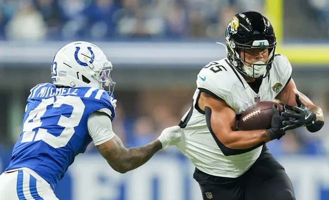Indianapolis Colts cornerback Cameron Mitchell (43) tackles Jacksonville Jaguars tight end Brenton Strange (85) on Sunday, Dec. 28, 2025, during a game at Lucas Oil Stadium in Indianapolis.