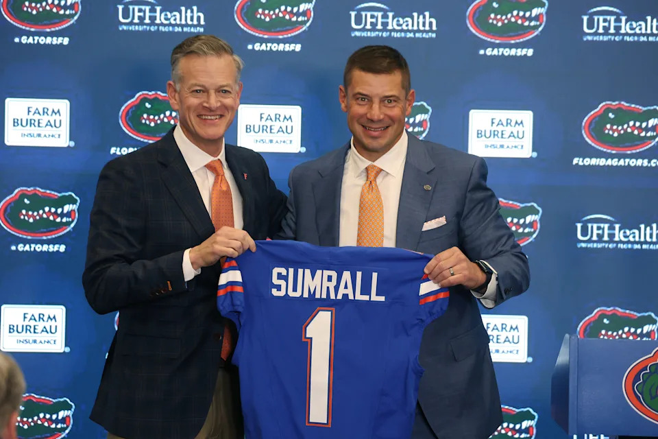 Jon Sumrall is introduced by athletic director Scott Stricklin as the new head coach of the University of Florida football team during a press conference on campus on Monday, Dec. 1, 2025. (Stephen M. Dowell/Orlando Sentinel/Tribune News Service via Getty Images)