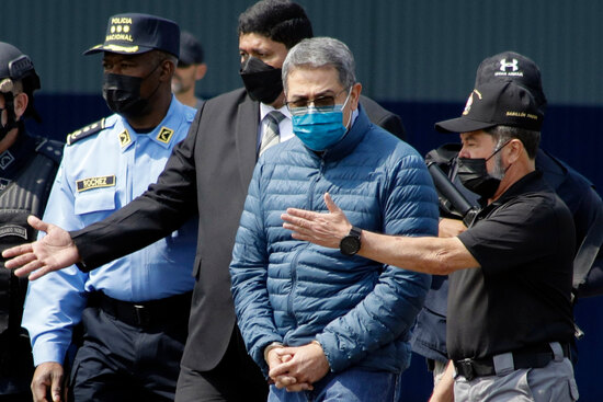 FILE - Former Honduran President Juan Orlando Hernandez, second from right, is taken in handcuffs to a waiting aircraft as he is extradited to the United States, at an Air Force base in Tegucigalpa, Honduras, April 21, 2022. (AP Photo/Elmer Martinez, File) FILE - Former Honduran President Juan Orlando Hernandez, second from right, is taken in handcuffs to a waiting aircraft as he is extradited to the United States, at an Air Force base in Tegucigalpa, Honduras, April 21, 2022. (AP Photo/Elmer Martinez, File)