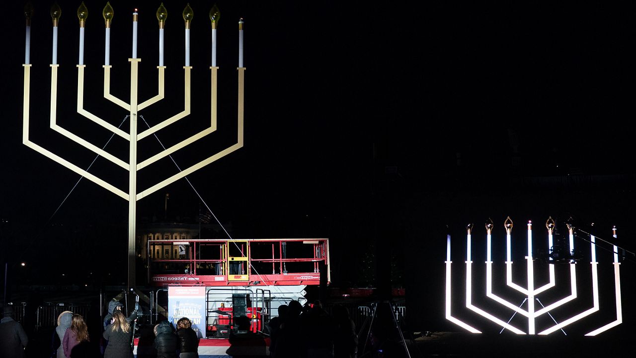 People look at the Menorah during the annual National Menorah Lighting in celebration of Hanukkah, on the Ellipse near the White House in Washington, Sunday, Dec. 14, 2025. (AP Photo/Jose Luis Magana)