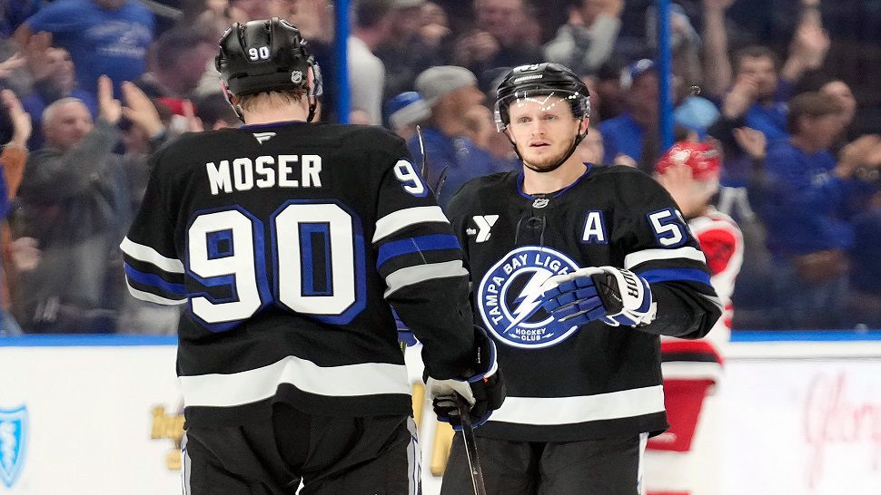 Tampa Bay Lightning center Jake Guentzel (59) celebrates his goal against the Carolina Hurricanes with defenseman J.J. Moser (90) during the third period of an NHL hockey game Saturday, Dec. 20, 2025, in Tampa, Fla. (AP Photo/Chris O'Meara)