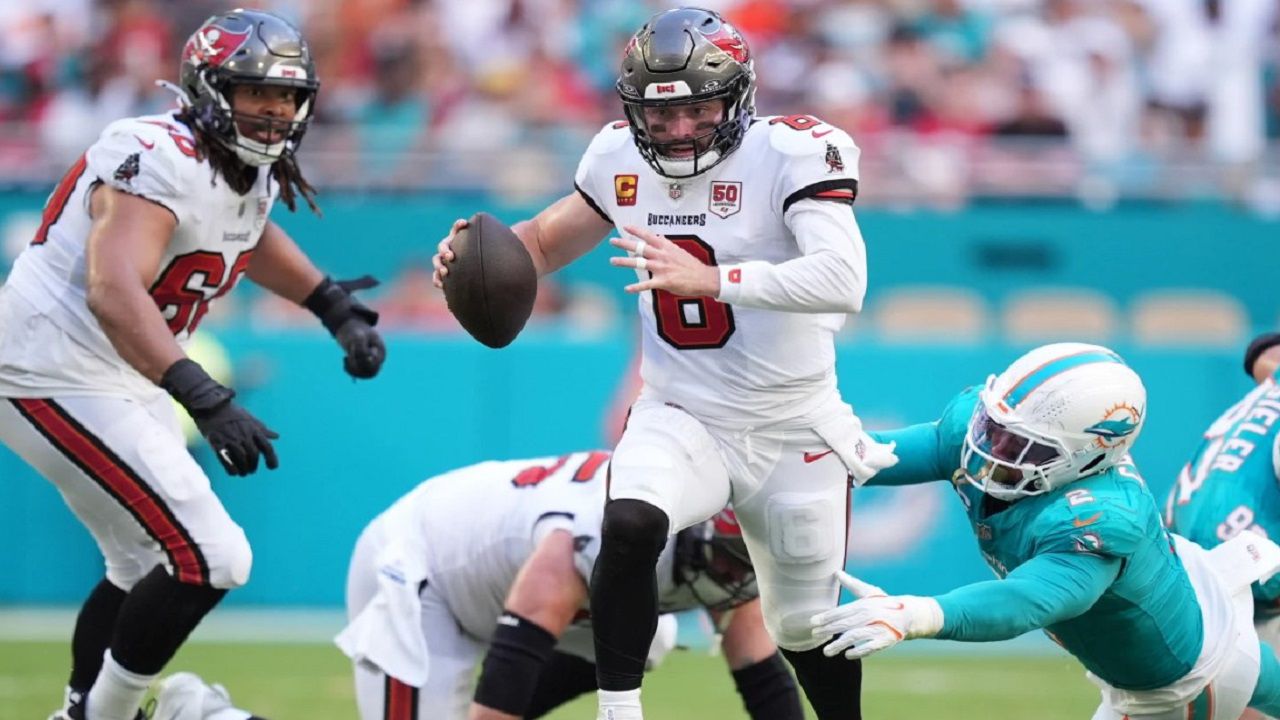 Tampa Bay quarterback Baker Mayfield runs to avoid Dolphins linebacker Bradley Chubb during Miami's 20-17 win Sunday. (AP Photo/Rebecca Blackwell)