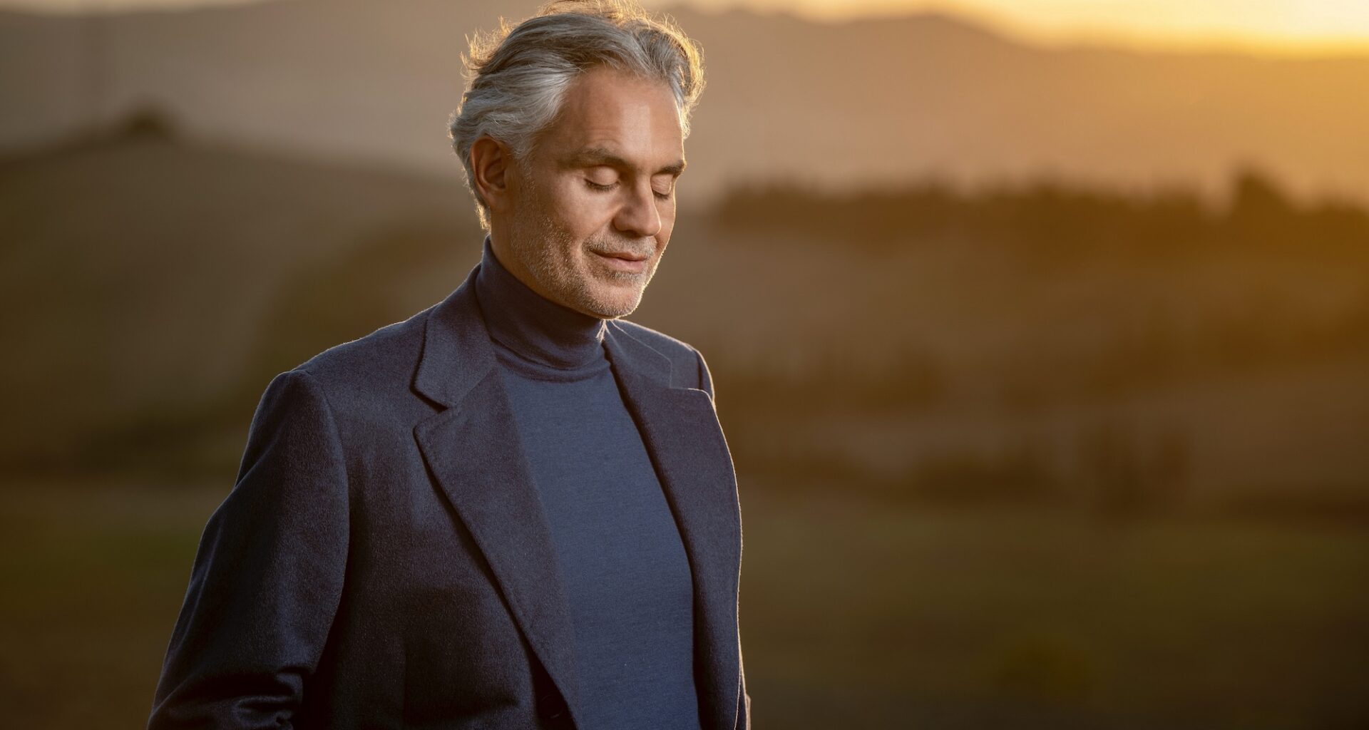 photo of singer Andrea Bocelli in front of a prarie