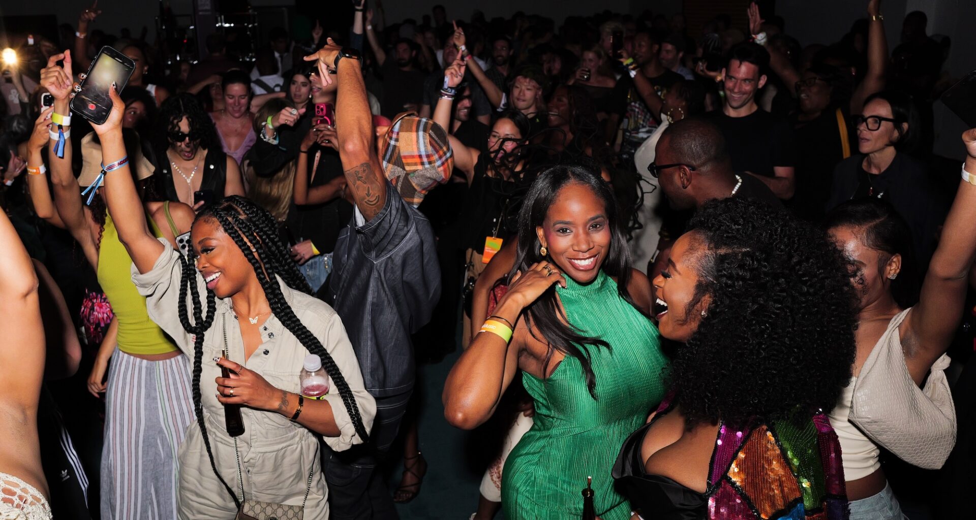 photo of people partying and posing for the camera on a dance floor