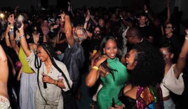 photo of people partying and posing for the camera on a dance floor