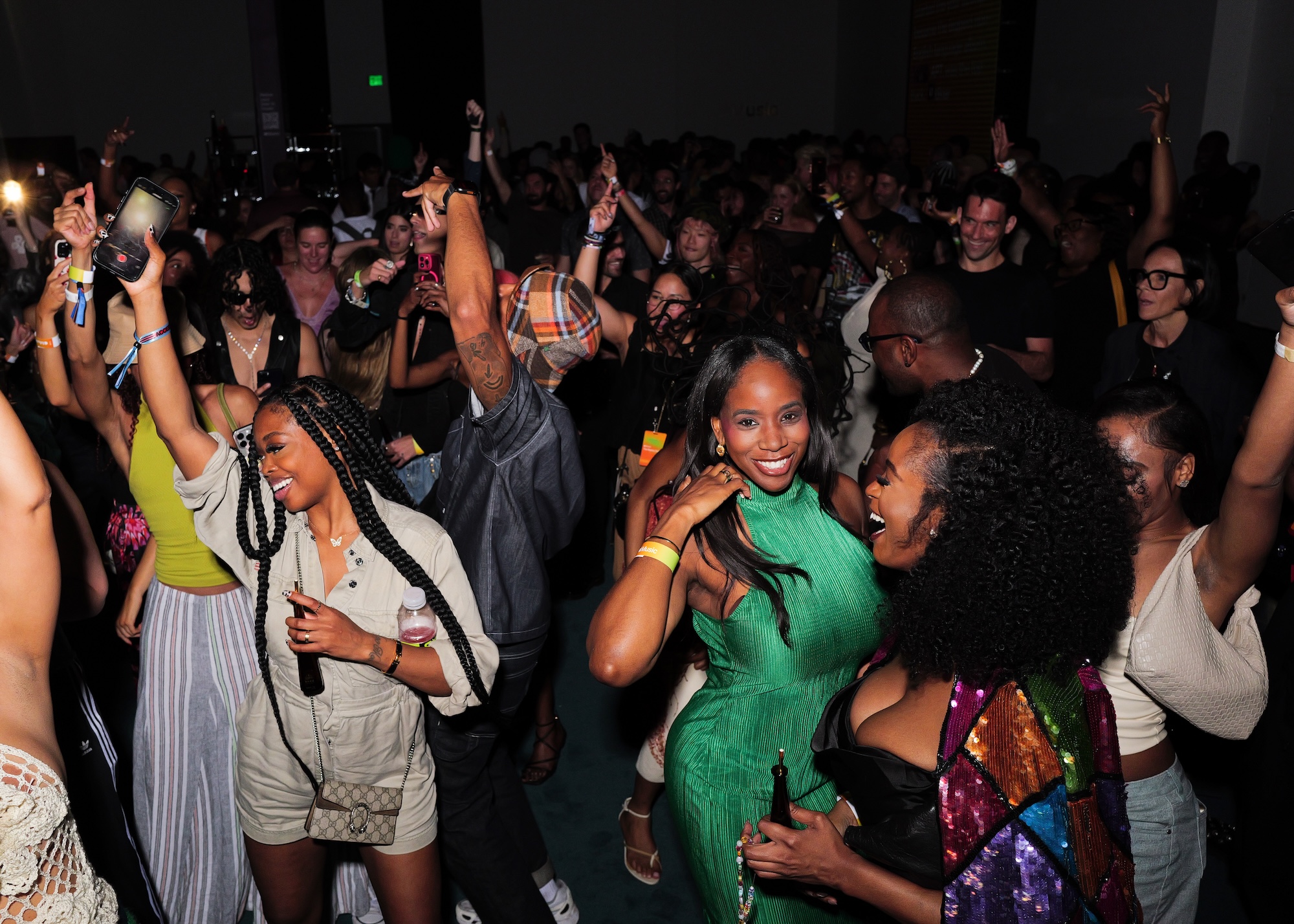 photo of people partying and posing for the camera on a dance floor