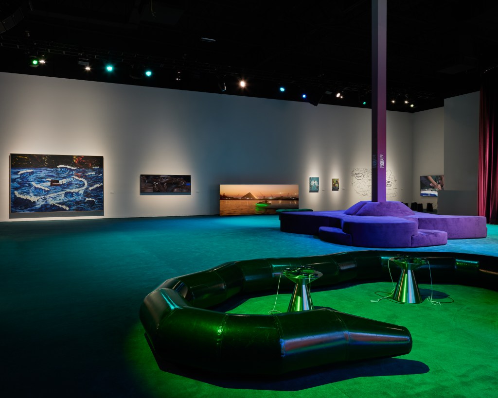 The Replay Gallery by Apple Music in Miami featuring modern, curvy furniture and colored lights.