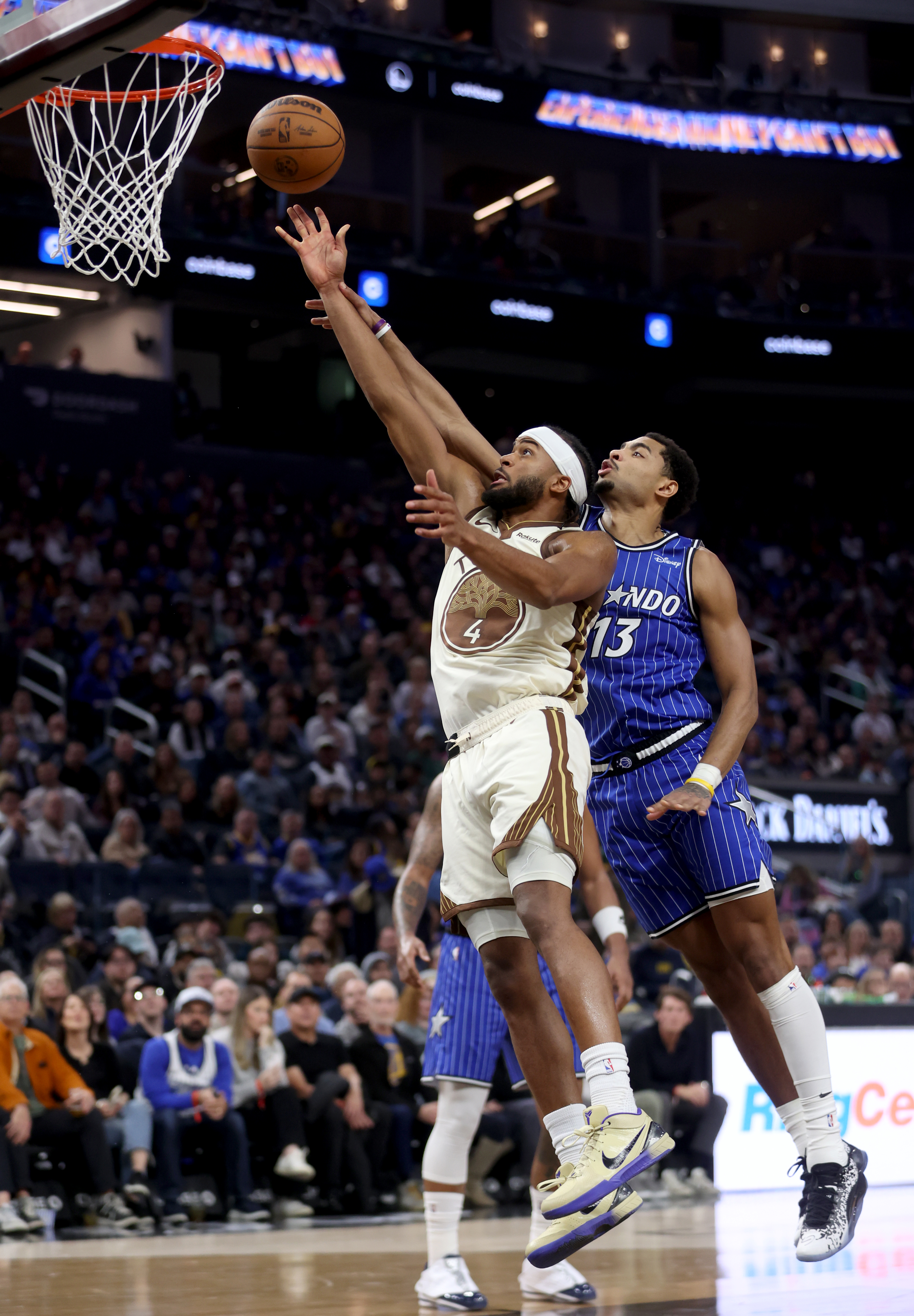 Golden State Warriors’ Moses Moody #4 is fouled by Orlando...