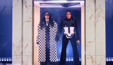 Two woman standing under a door frame holding hands