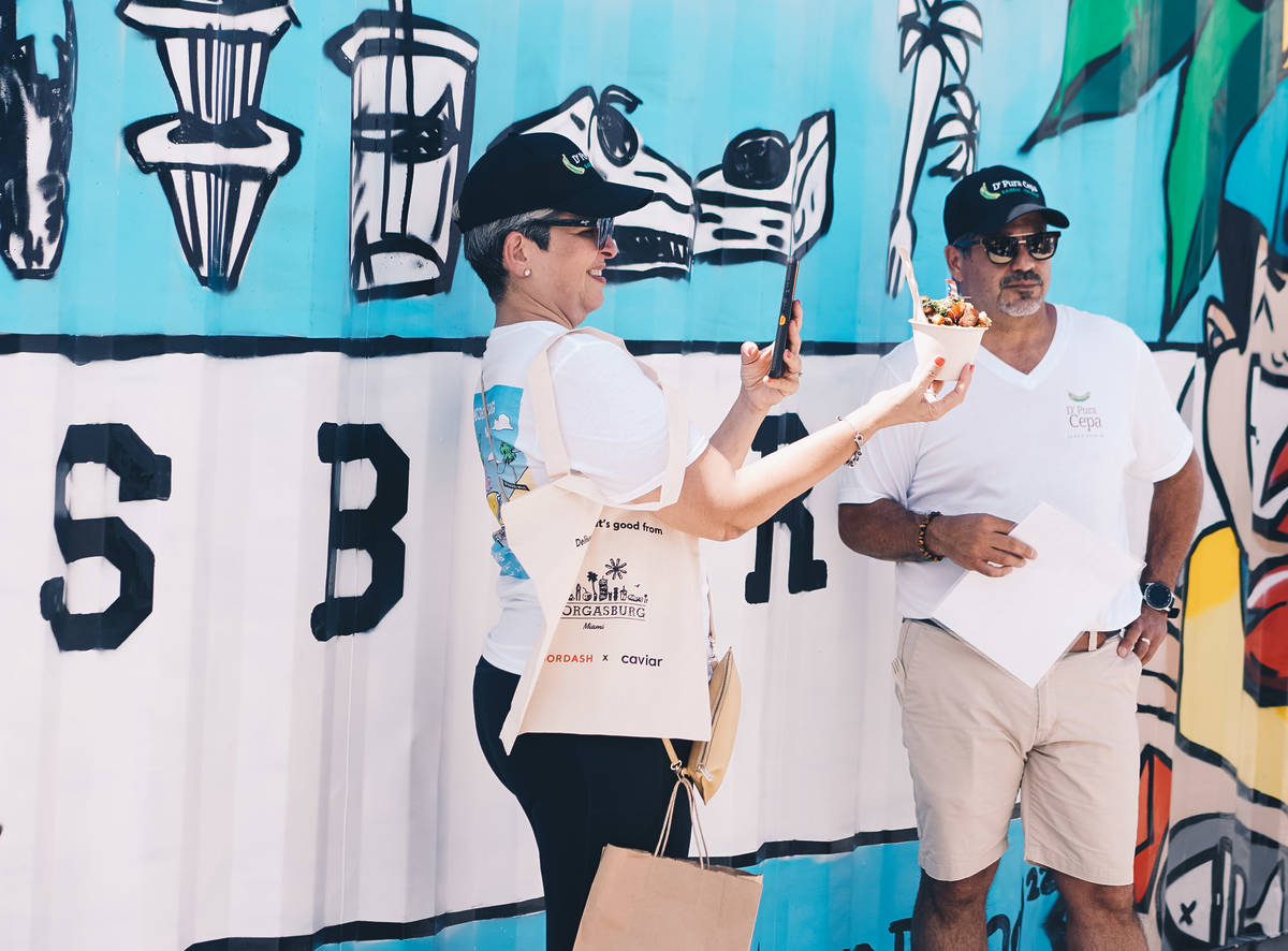 Person snaps a photo of their food at Smorgasburg