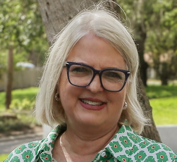 Left to Right, Orange County Mayor Jerry L. Demings;District 2 Commissioner Christine Moore; Orange County Utilities Deputy Director Marc Cannata; and District 3 Commissioner Mayra Uribe; pose for a photo with a completed 500-piece puzzle of Wekiva Springs during an event to commemorate the 500th connection in the Septic 2 Sewer program, at The Palms subdivision in Apopka, on Monday, May 5, 2025. 