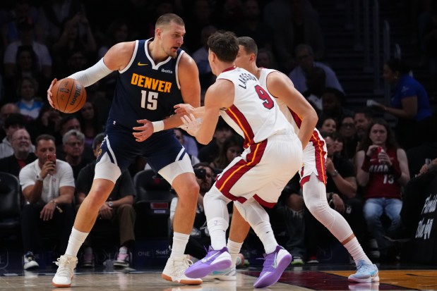 MIAMI, FLORIDA - DECEMBER 29: Nikola Jokic #15 of the Denver Nuggets dribbles the ball against Pelle Larsson #9 of the Miami Heat during the second quarter at Kaseya Center on December 29, 2025 in Miami, Florida. NOTE TO USER: User expressly acknowledges and agrees that, by downloading and or using this photograph, User is consenting to the terms and conditions of the Getty Images License Agreement. (Photo by Rich Storry/Getty Images)