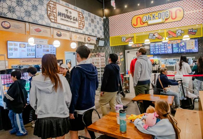 a crowd at the H Mart food court