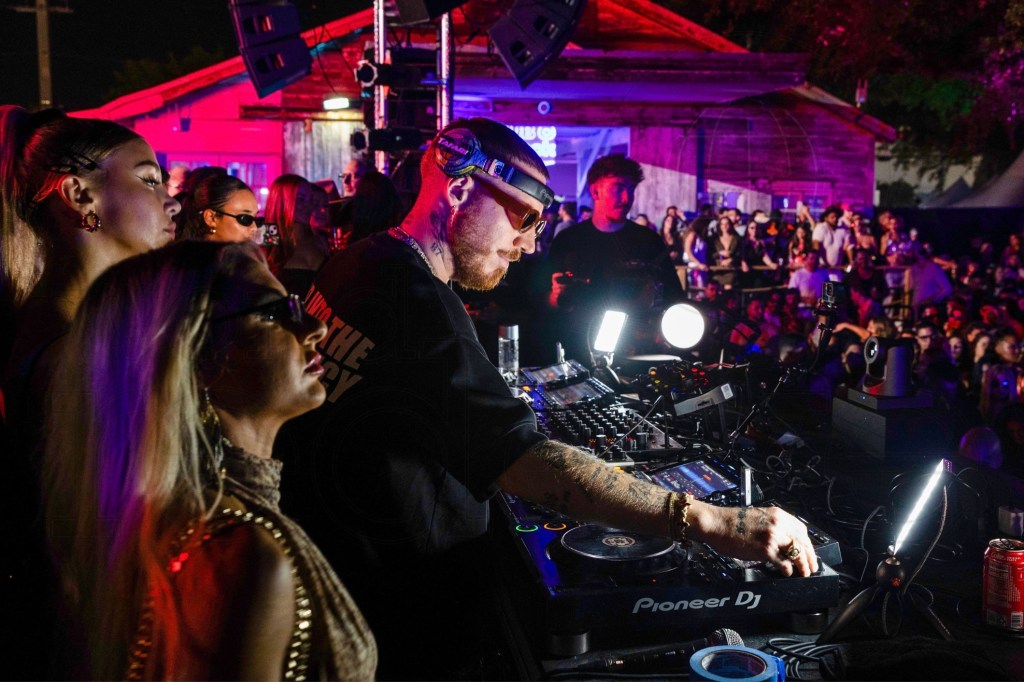 photo of Hugel behind a DJ booth