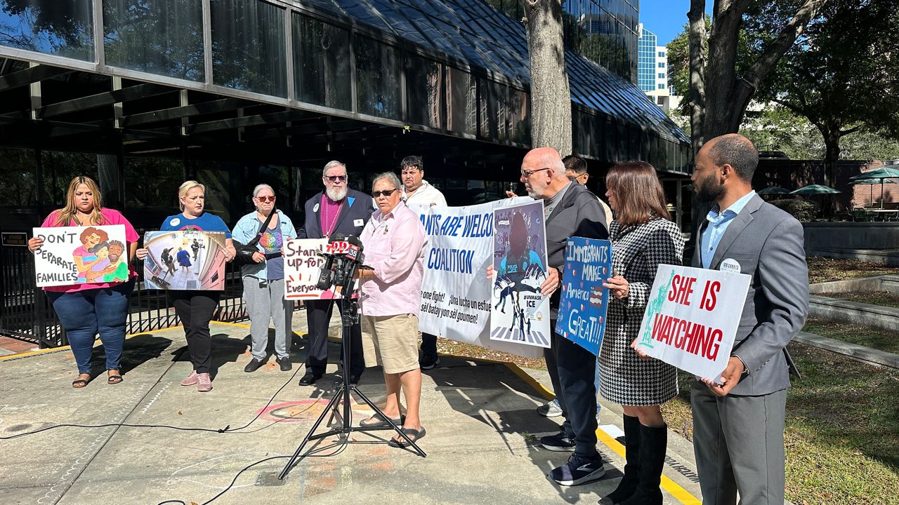 Leaders with several local organizations that support immigrants gather outside the Orange County Administration Building Tuesday for a press conference to discuss concerns about the increase of ICE detainees at the Orange County Jail. (Spectrum News 13/Massiel Leyva)