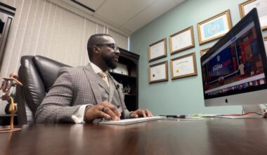 Ricardeau Lucceos, known as the community lawyer, works in his office. (Spectrum News/Lizbeth Gutierrez)