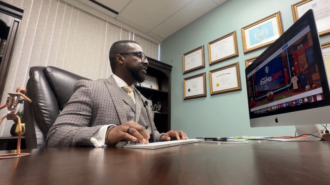 Ricardeau Lucceos, known as the community lawyer, works in his office. (Spectrum News/Lizbeth Gutierrez)