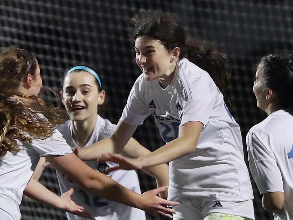 Hagerty's Reagan Fitzgerald (20) celebrates with teammates Tuesday after scoring...