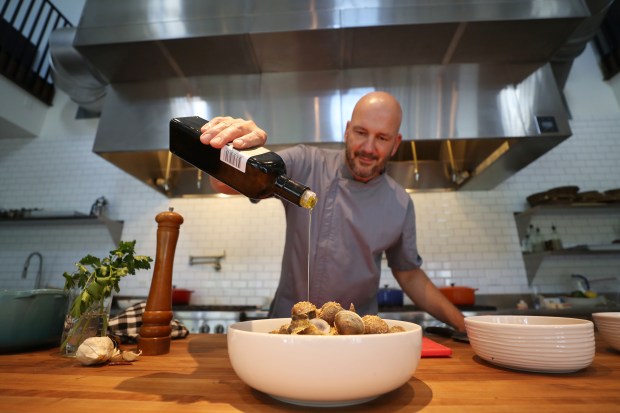 Chef Kevin Fonzo prepares linguine and clams as part of the tradition of the Feast of the Seven Fishes, at the Kitchen House. He does it year-round, as well, as it's among his most-requested dishes. 