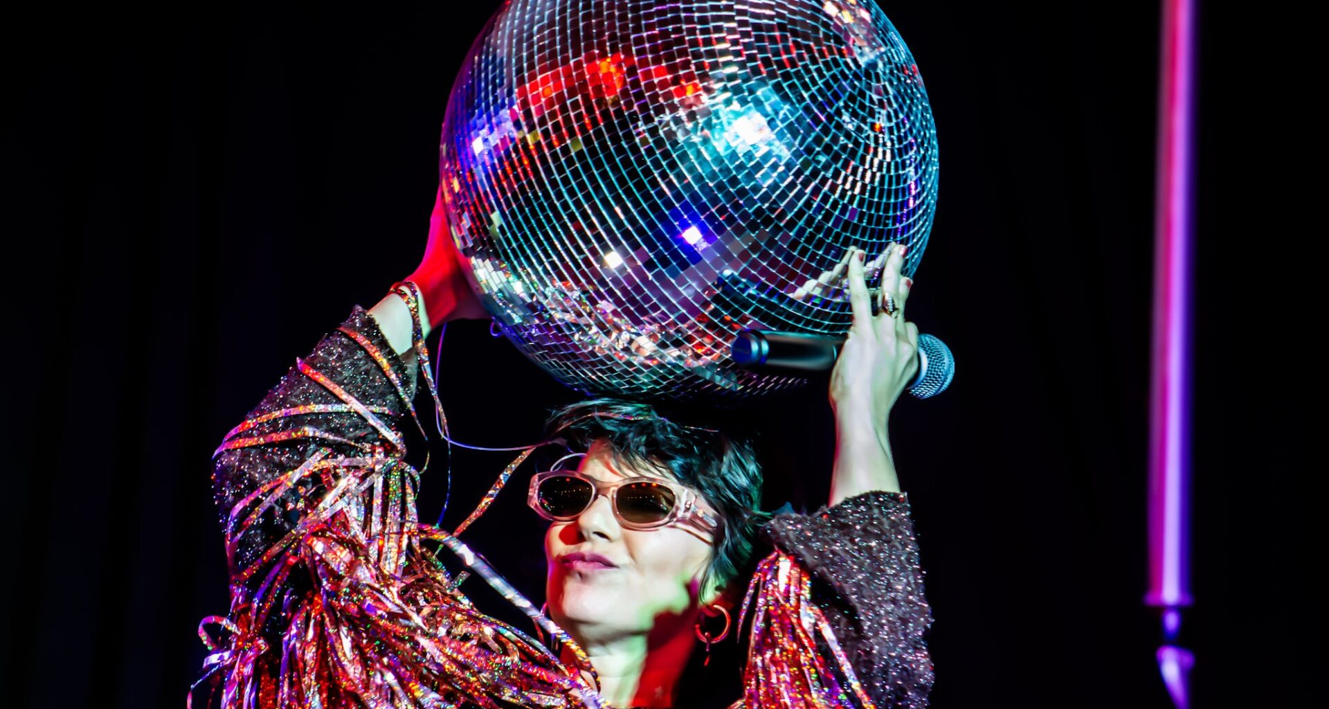Photo of a woman holding a disco ball