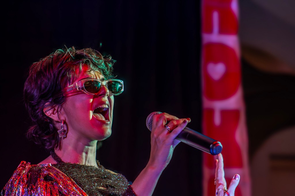 Photo of a  woman singing with a microphone