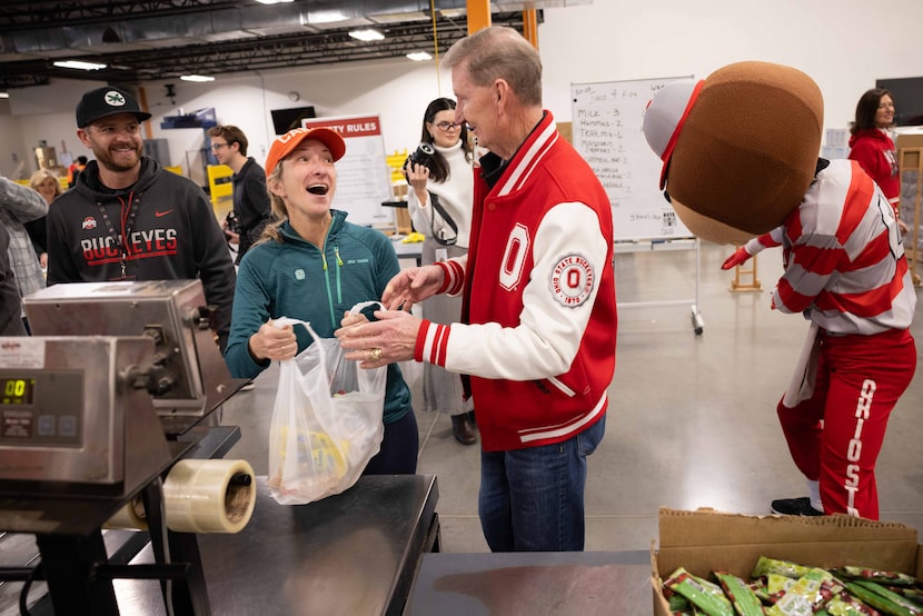 University of Miami alumna Quinn Solomon of New Jersey talks to Ohio State President Ted...