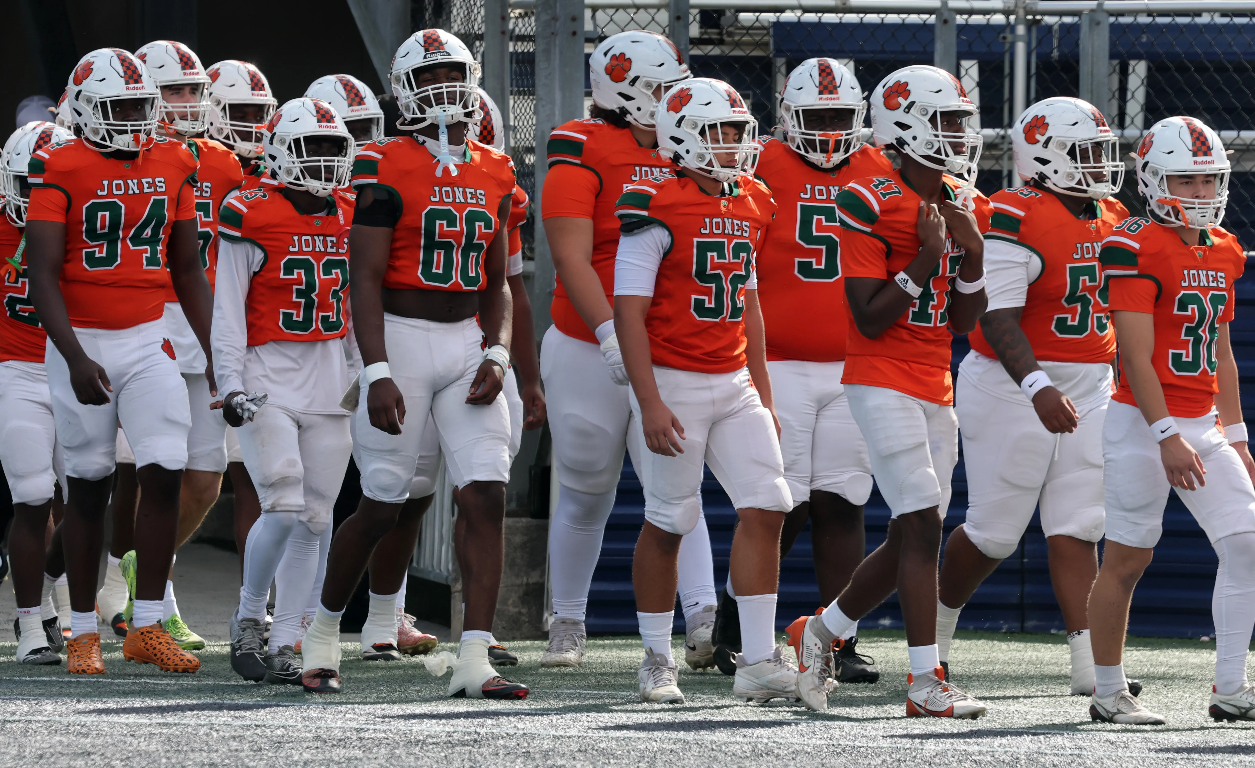 The Jones High School football team takes the field for...