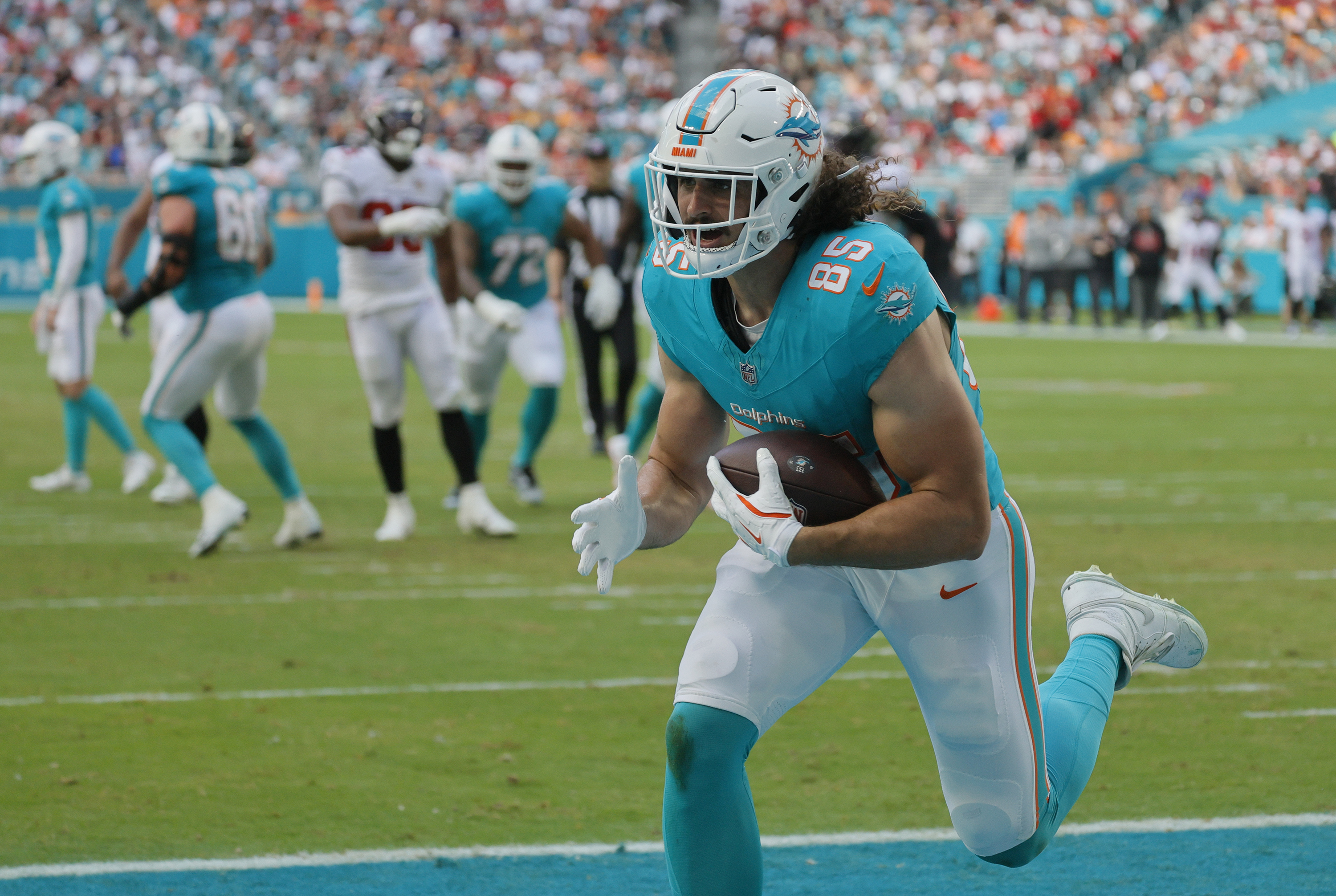 Miami Dolphins tight end Greg Dulcich (85) runs in a...