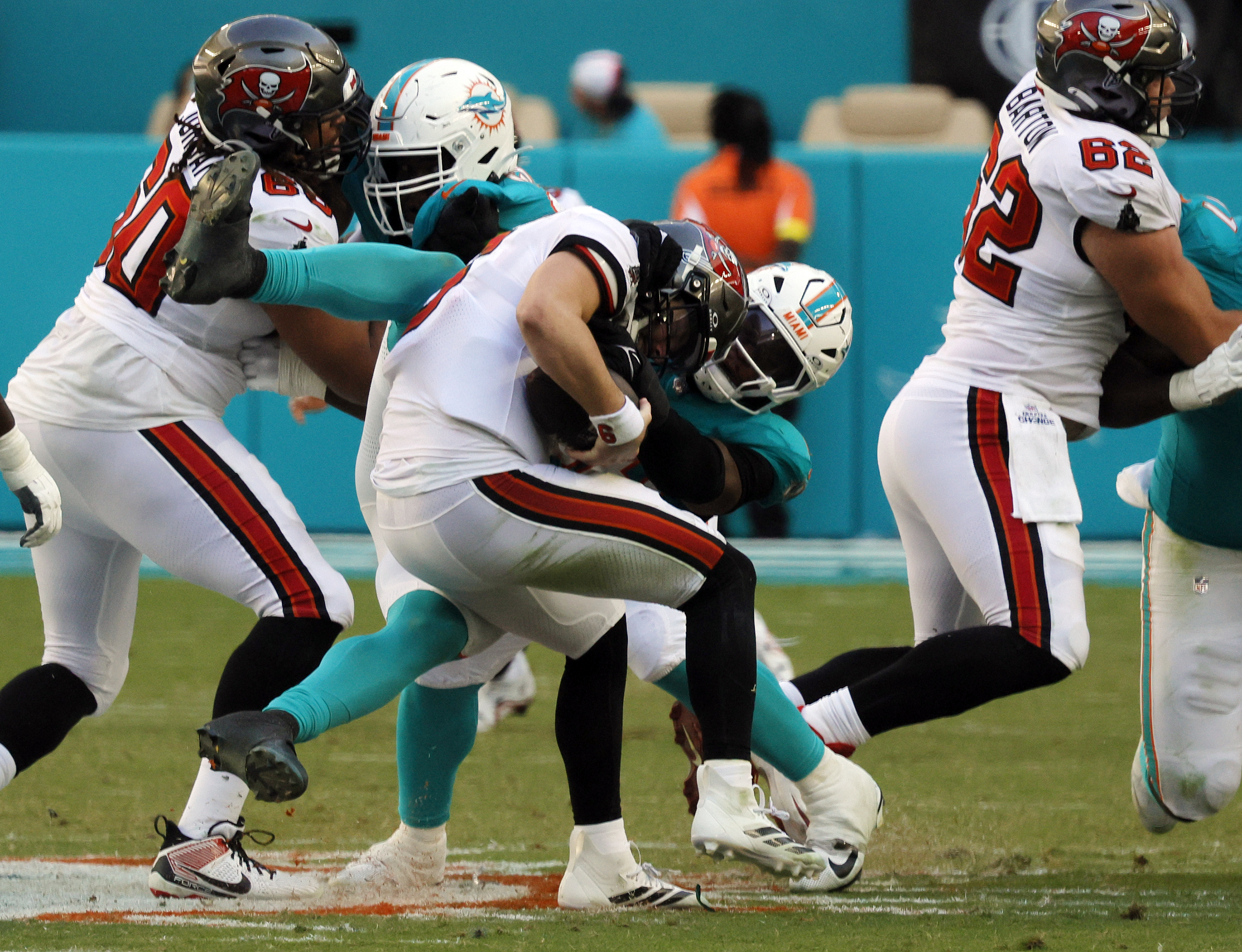 Miami Dolphins linebacker Quinton Bell (56) grabs bu canât bring...