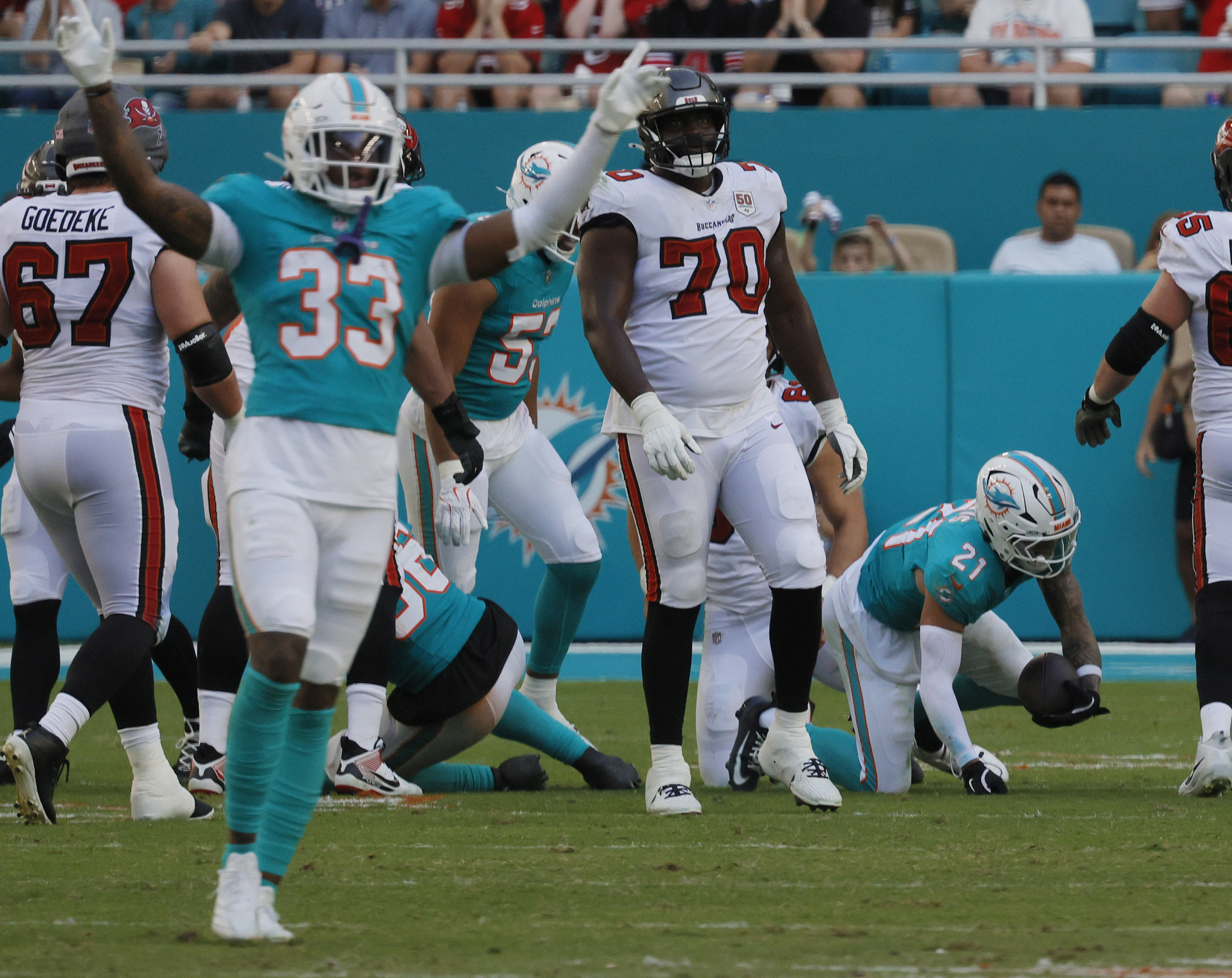 Miami Dolphins safety Ashtyn Davis (21) gets up after interce[pting...