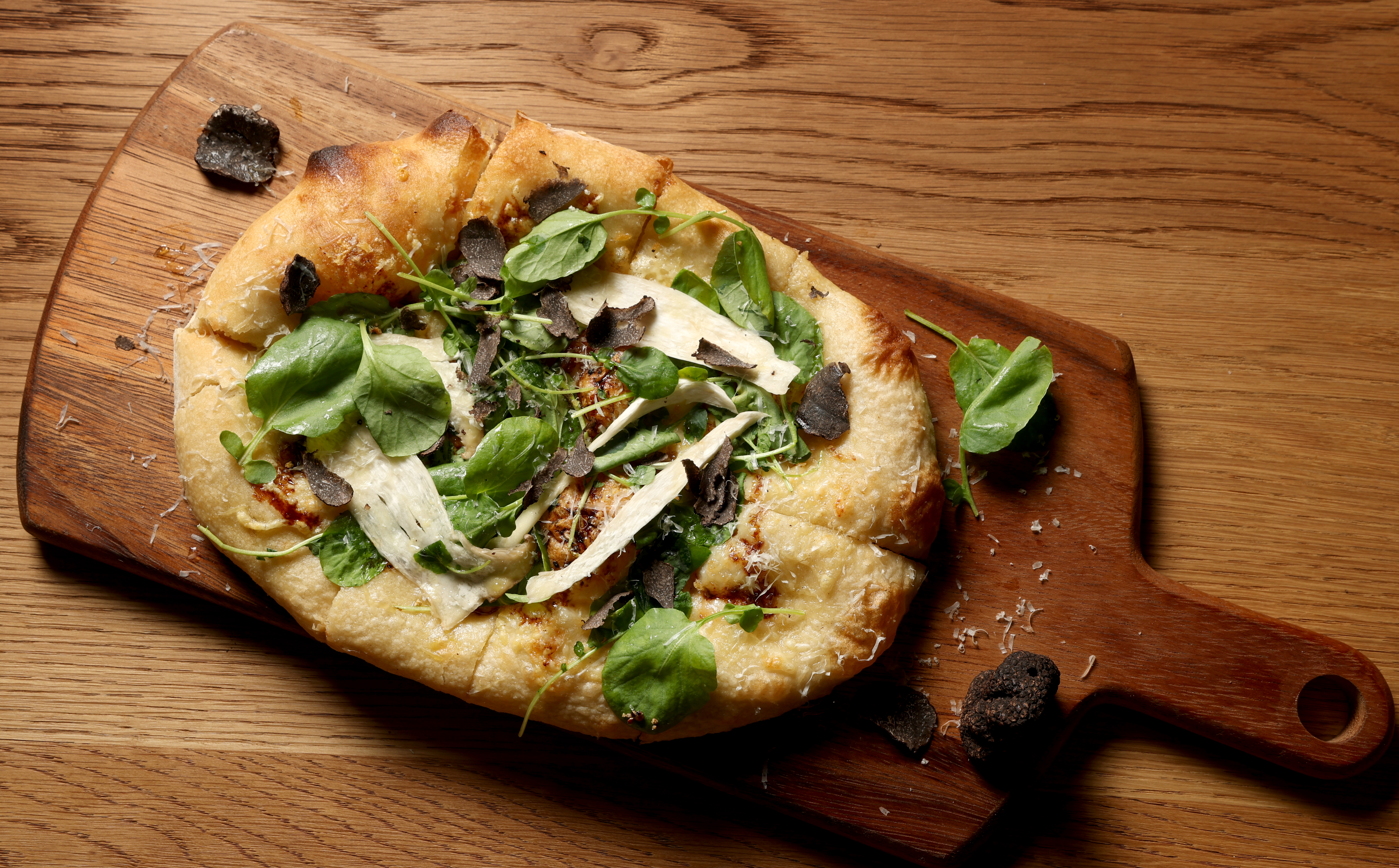 Sourdough flatbread with black truffle, caramelized onion, fontal cheese, aged...