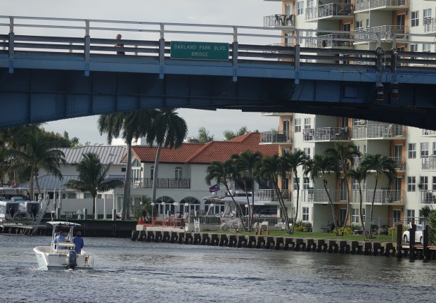 A boat on the Intracoastal Waterway passes under the Oakland Park Boulevard bridge on Tuesday in Fort Lauderdale. (Joe Cavaretta/South Florida Sun Sentinel)