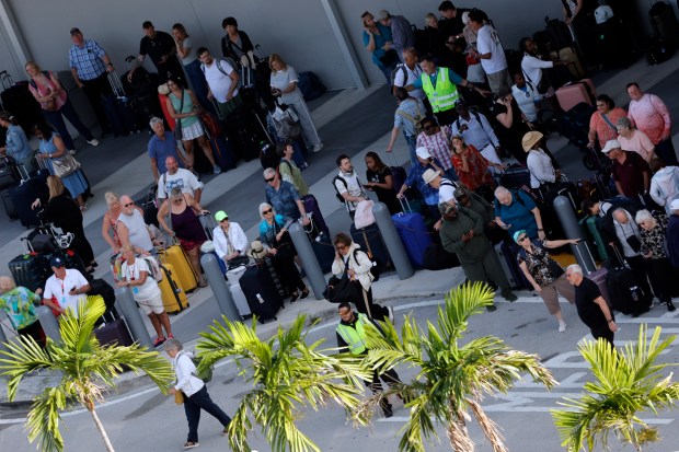 Cruise passengers wait for transportation after disembarking from the Celebrity Ascent docked at Port Everglades on Friday, Dec. 12, 2025. (Amy Beth Bennett / South Florida Sun Sentinel)