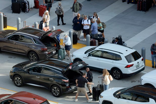 Cruise passengers wait for transportation after disembarking from the Celebrity Ascent docked at Port Everglades on Friday, Dec. 12, 2025. (Amy Beth Bennett / South Florida Sun Sentinel)